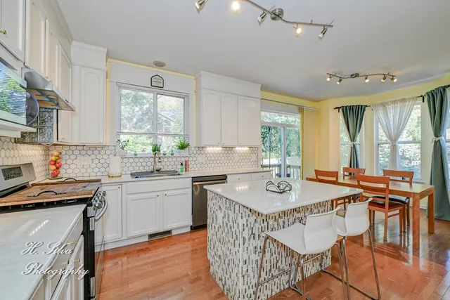 a kitchen with stainless steel appliances a stove a sink a stove a microwave and cabinets