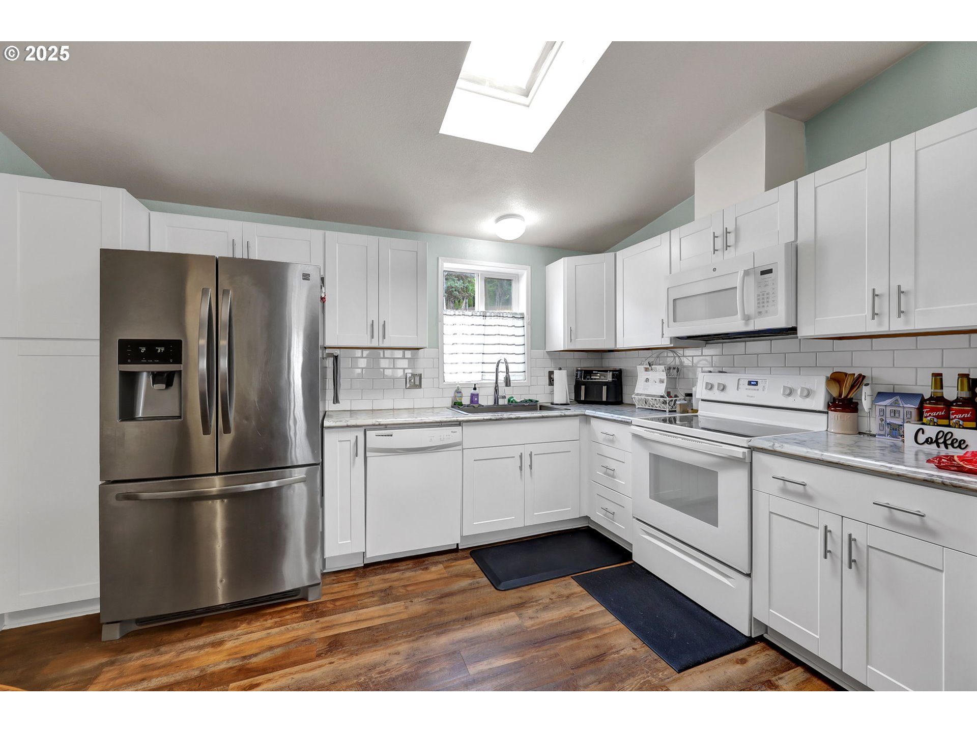 991 Main Street Monroe, OR 97456 - Photo 13 of 48 a kitchen with stainless steel appliances granite countertop a refrigerator sink and white cabinets