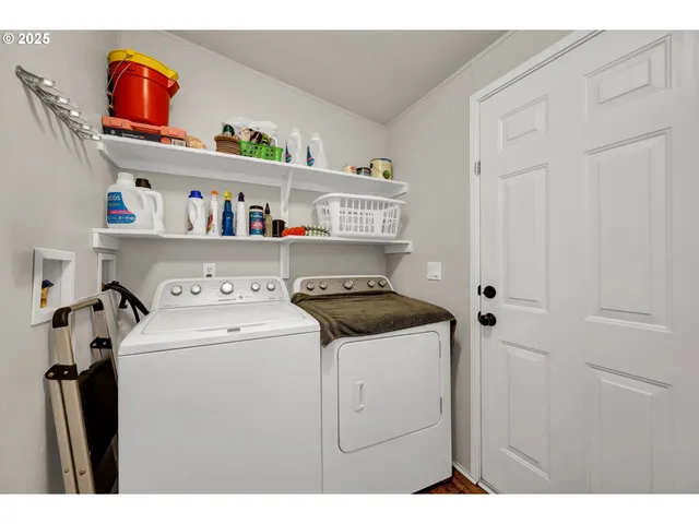 a utility room with dryer washer and a fridge