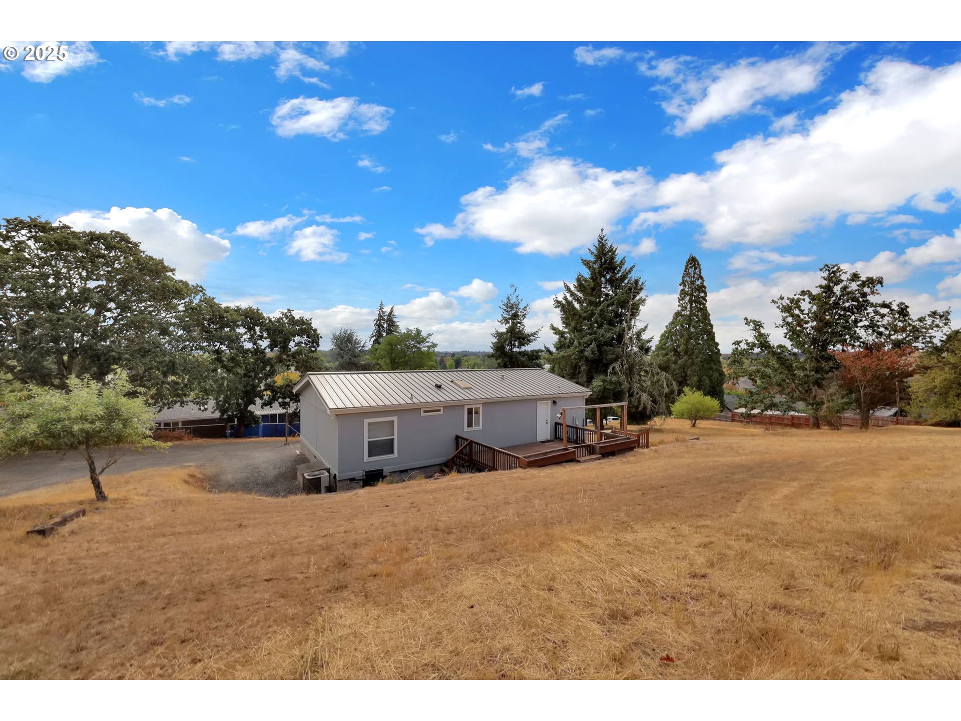 991 Main Street Monroe, OR 97456 - Photo 3 of 48 a view of a yard with large trees