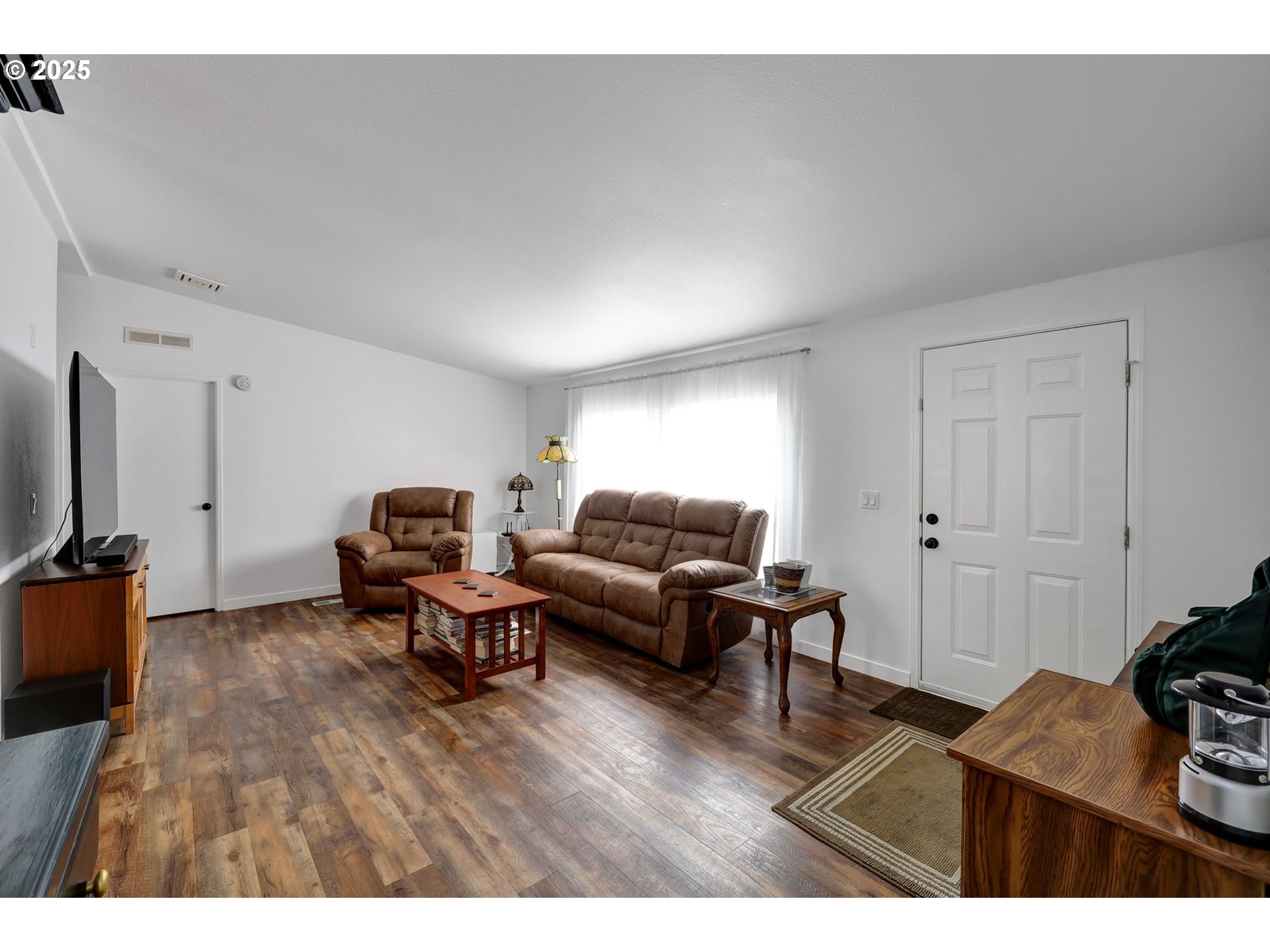 991 Main Street Monroe, OR 97456 - Photo 43 of 48 a living room with furniture a flat screen tv and a window