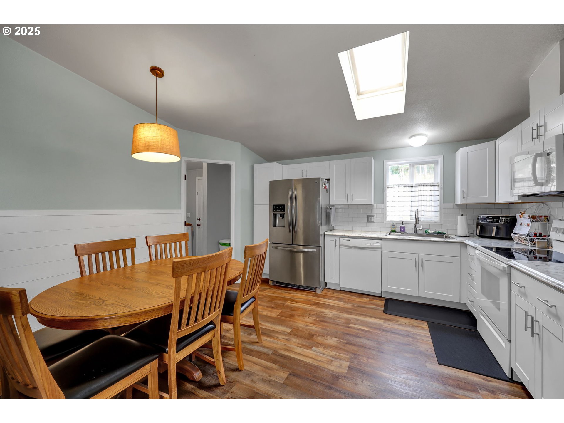 991 Main Street Monroe, OR 97456 - Photo 7 of 48 a kitchen with stainless steel appliances kitchen island granite countertop a sink a stove a dining table and chairs