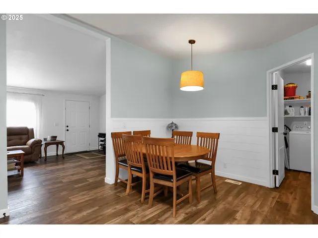 a dining room with furniture and wooden floor