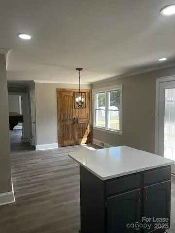 a kitchen with a sink cabinets and wooden floor