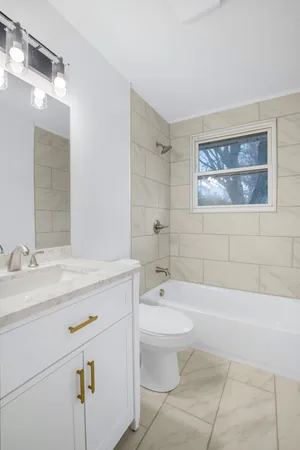 a bathroom with a sink a toilet and bathtub