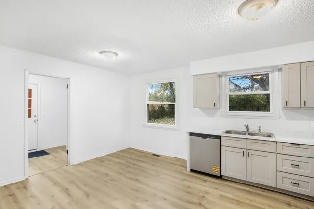 a kitchen with a sink cabinets and a window