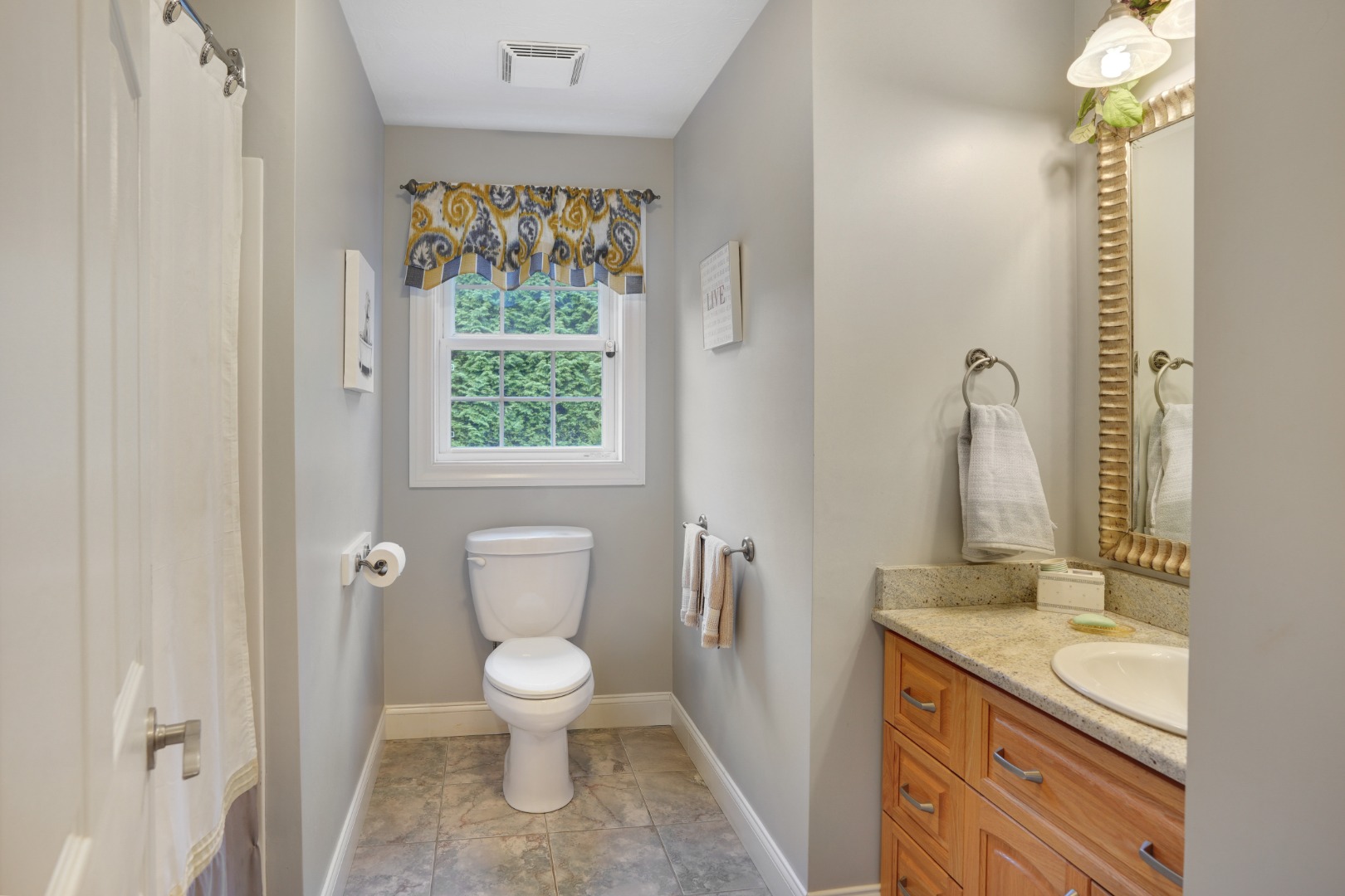8 Fresh Pond Road Oak Bluffs, MA 02557 - Photo 15 of 36 a bathroom with a granite countertop toilet a sink and a mirror