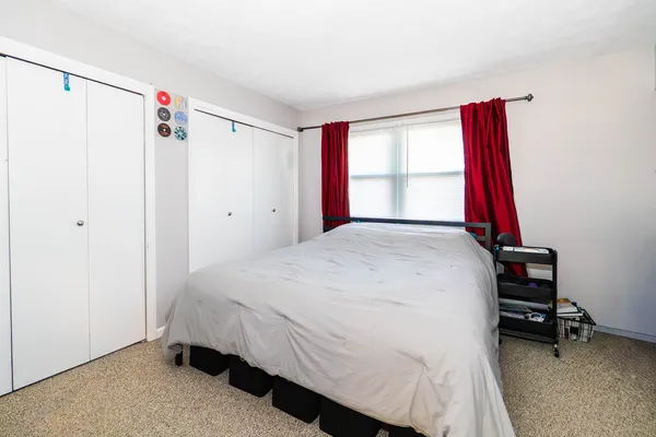 a bedroom with a bed and a window