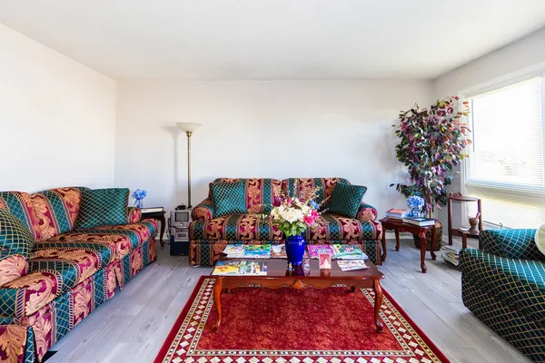 a bed room with furniture and a potted plant