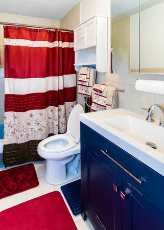 a bathroom with a sink a toilet and shower curtain