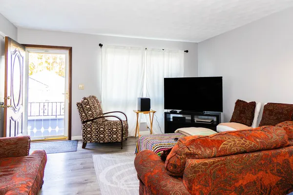 a bedroom with furniture and a flat screen tv
