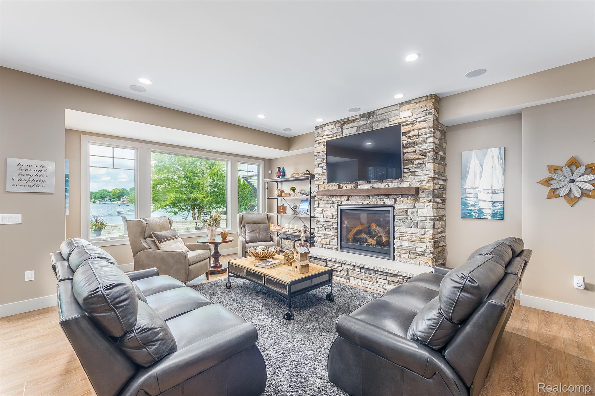 8309 Hilton Road Brighton, MI 48114 - Photo 37 of 56 Gather around the stone faced gas fireplace and enjoy watching movies with family and friends
