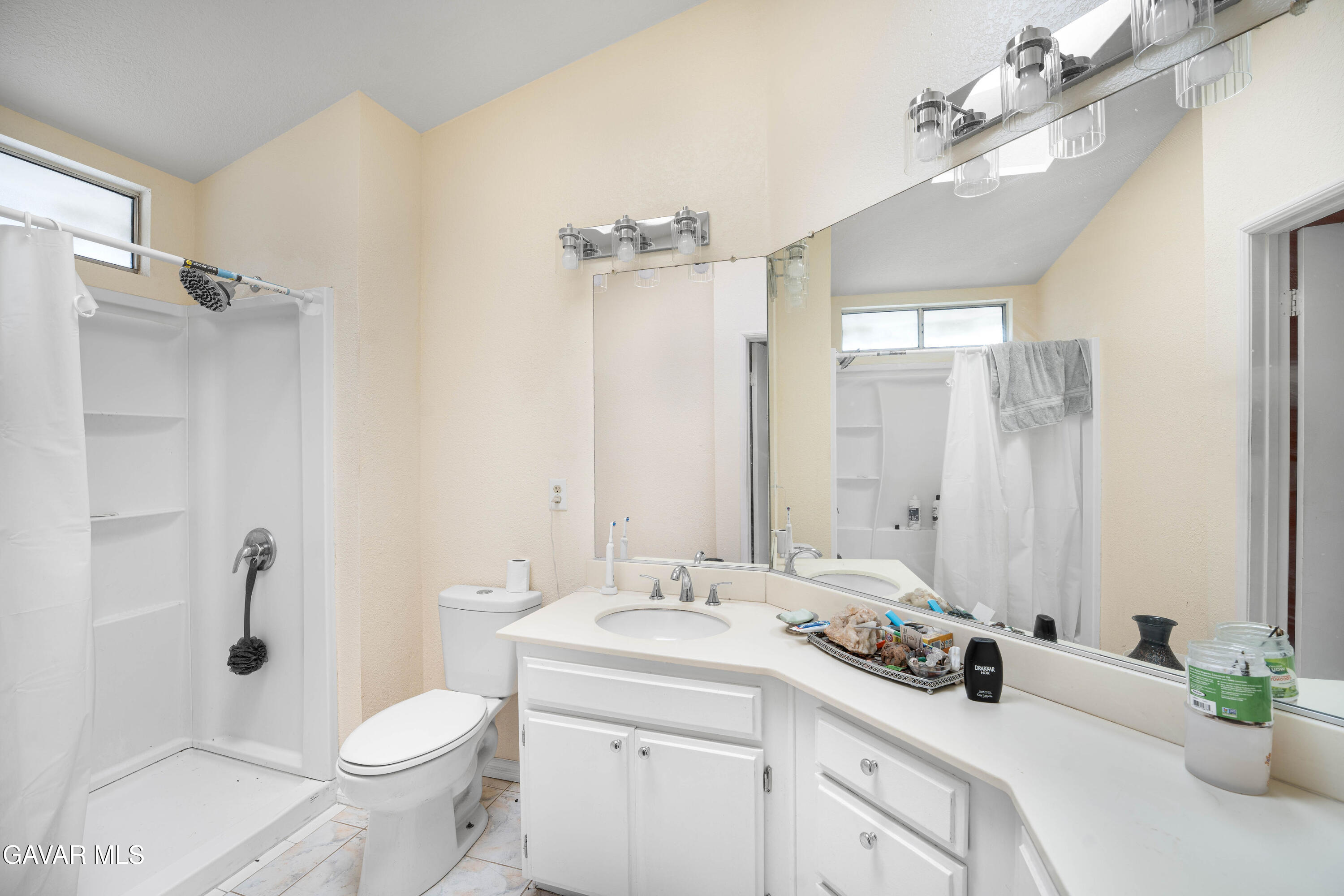 5009 East Ave R 11 Palmdale, CA 93552 - Photo 21 of 23 a bathroom with a double vanity sink toilet and shower