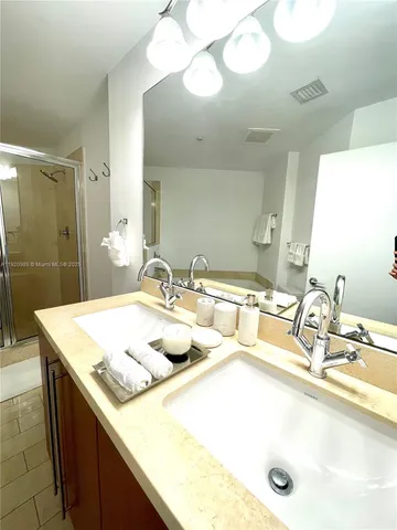 a bathroom with a sink double vanity and a mirror