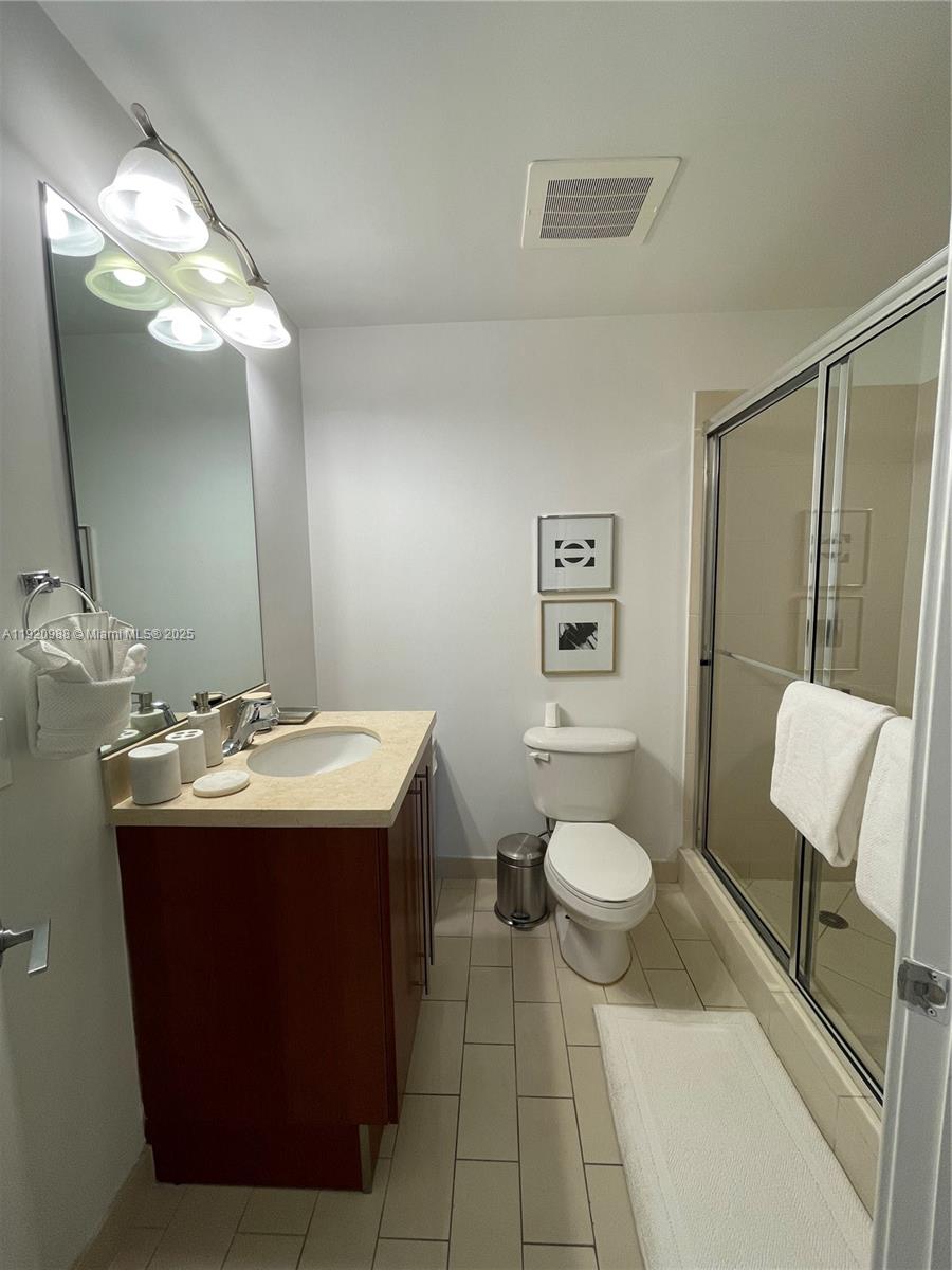 79 Southwest 12th Street, Unit 2407S Miami, FL 33130 - Photo 13 of 35 a bathroom with a sink and a mirror