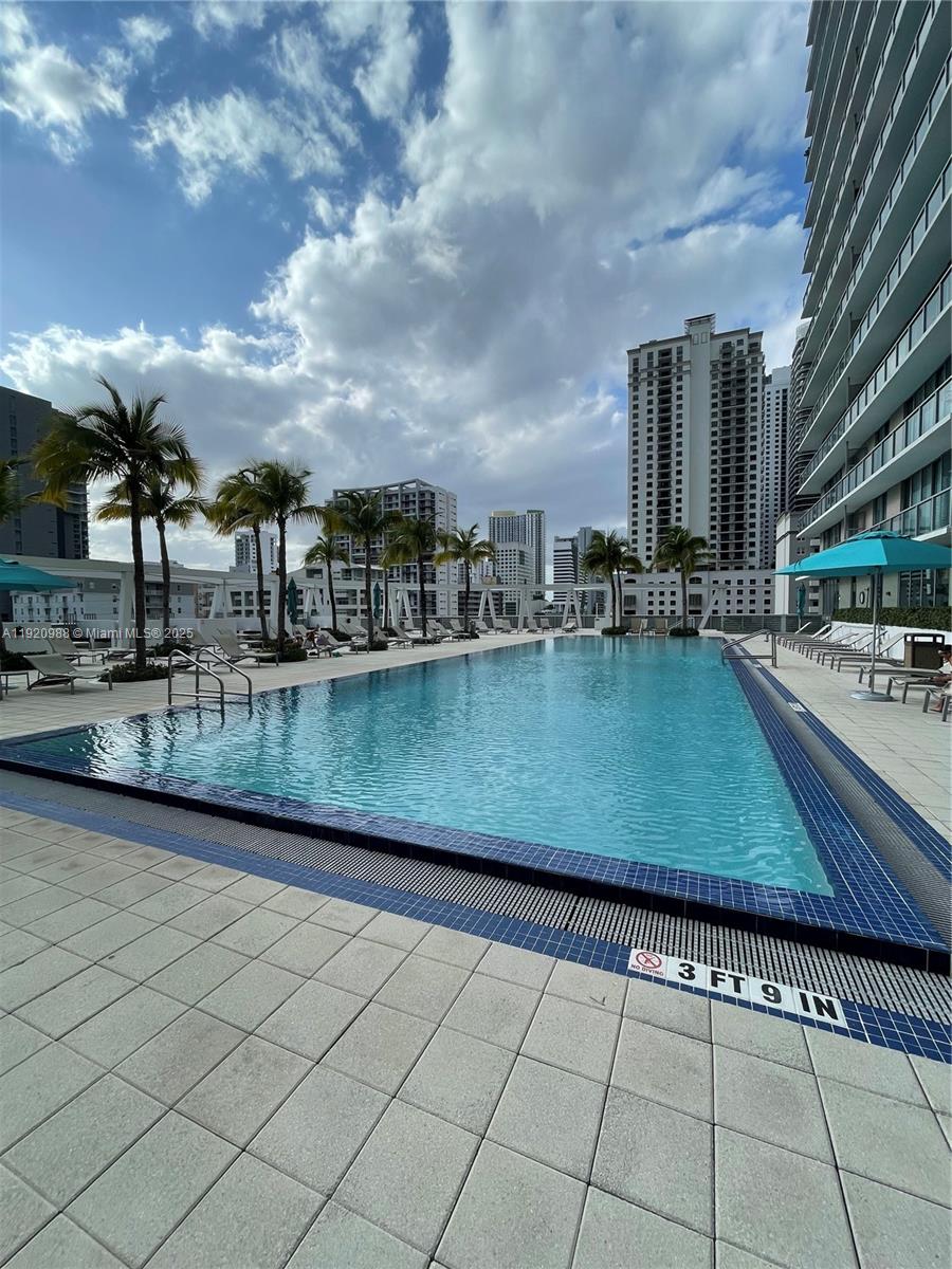 79 Southwest 12th Street, Unit 2407S Miami, FL 33130 - Photo 21 of 35 a view of swimming pool with outdoor seating and barbeque oven