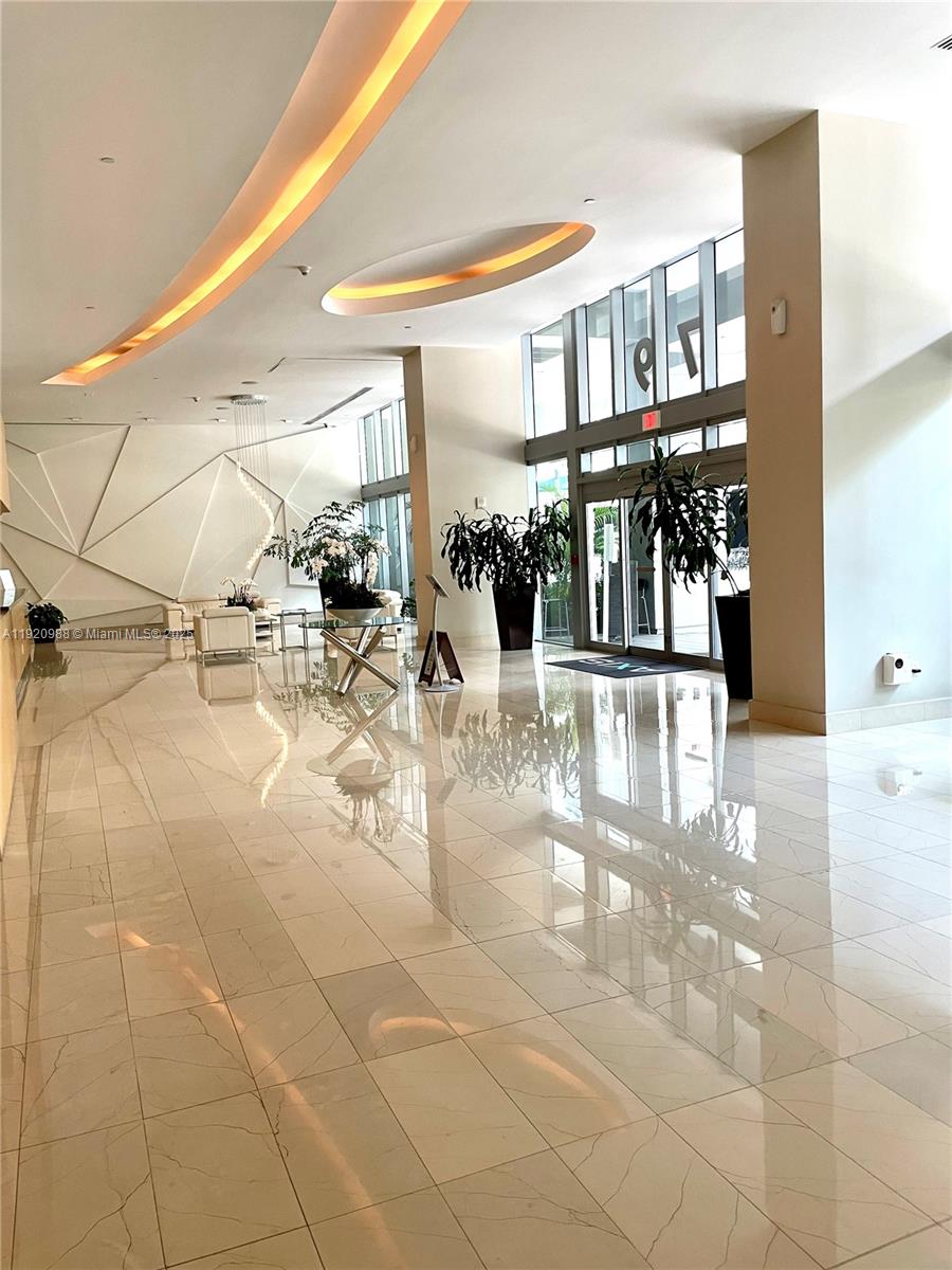 79 Southwest 12th Street, Unit 2407S Miami, FL 33130 - Photo 28 of 35 a view of a livingroom with dining area a chandelier and entryway