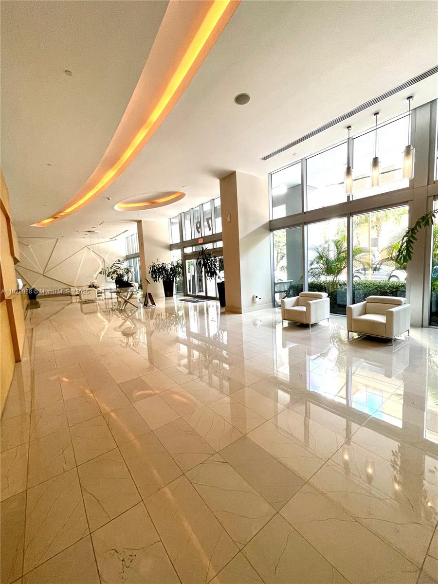 79 Southwest 12th Street, Unit 2407S Miami, FL 33130 - Photo 29 of 35 a lobby with furniture and a floor to ceiling window
