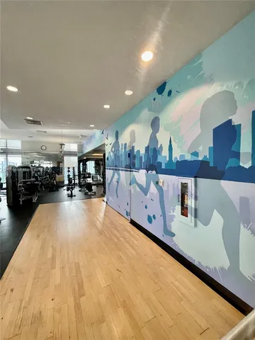 a view of living room with furniture and view of large mirror