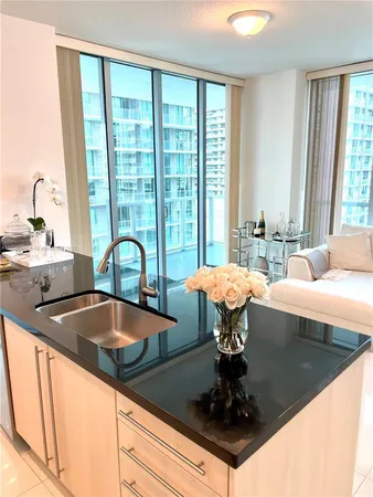 a kitchen with a sink and large window