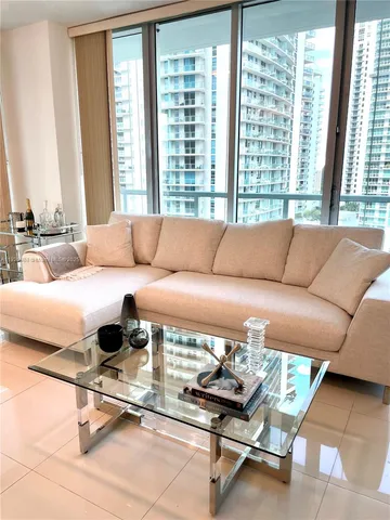 a living room with a couch and a large window