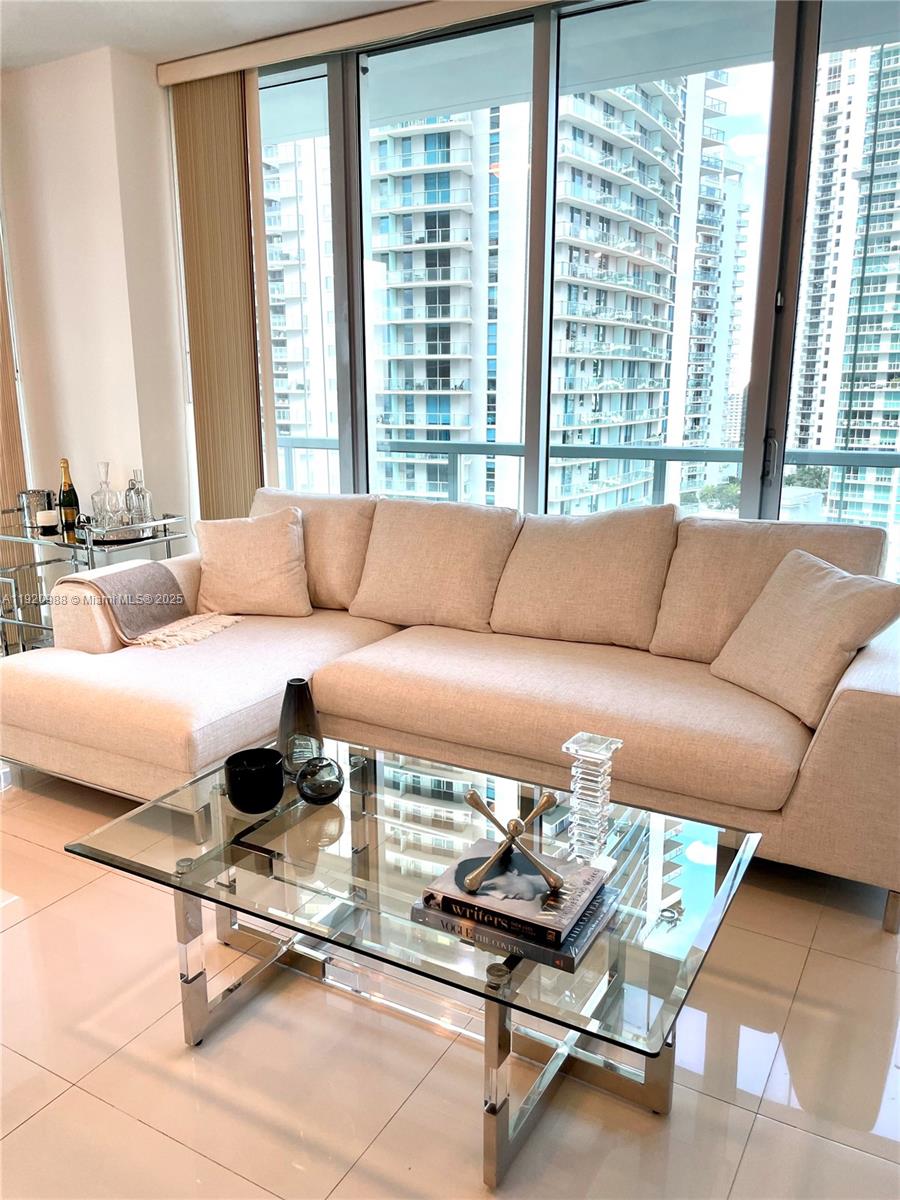 79 Southwest 12th Street, Unit 2407S Miami, FL 33130 - Photo 4 of 35 a living room with a couch and a large window