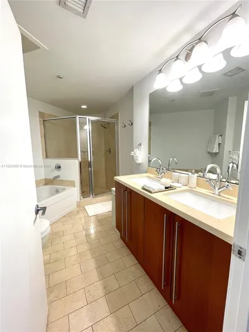 a large bathroom with a sink mirror and shower