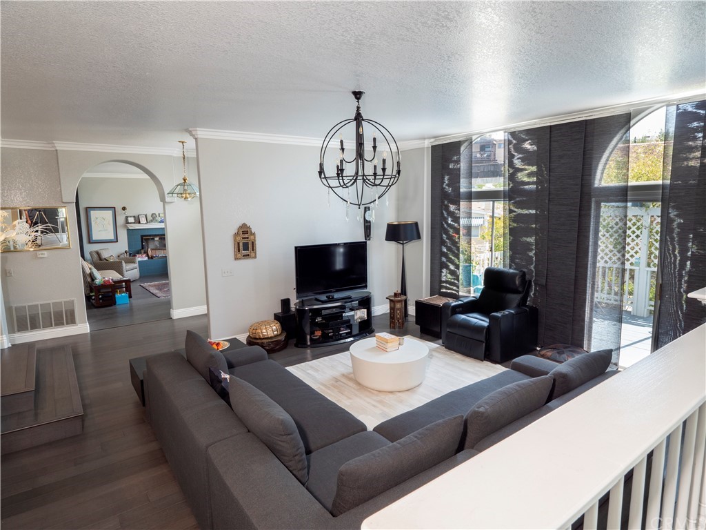 33881 Orilla Road Dana Point, CA 92629 - Photo 22 of 37 a living room with furniture a chandelier and a flat screen tv