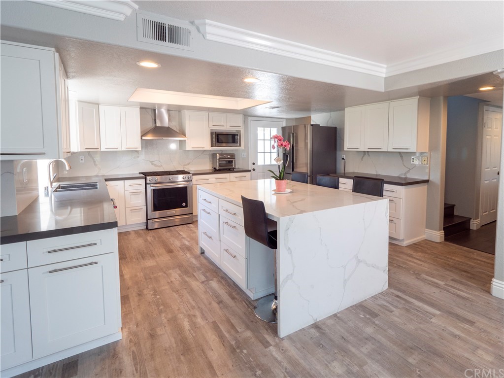 33881 Orilla Road Dana Point, CA 92629 - Photo 26 of 37 a kitchen with white cabinets and white appliances