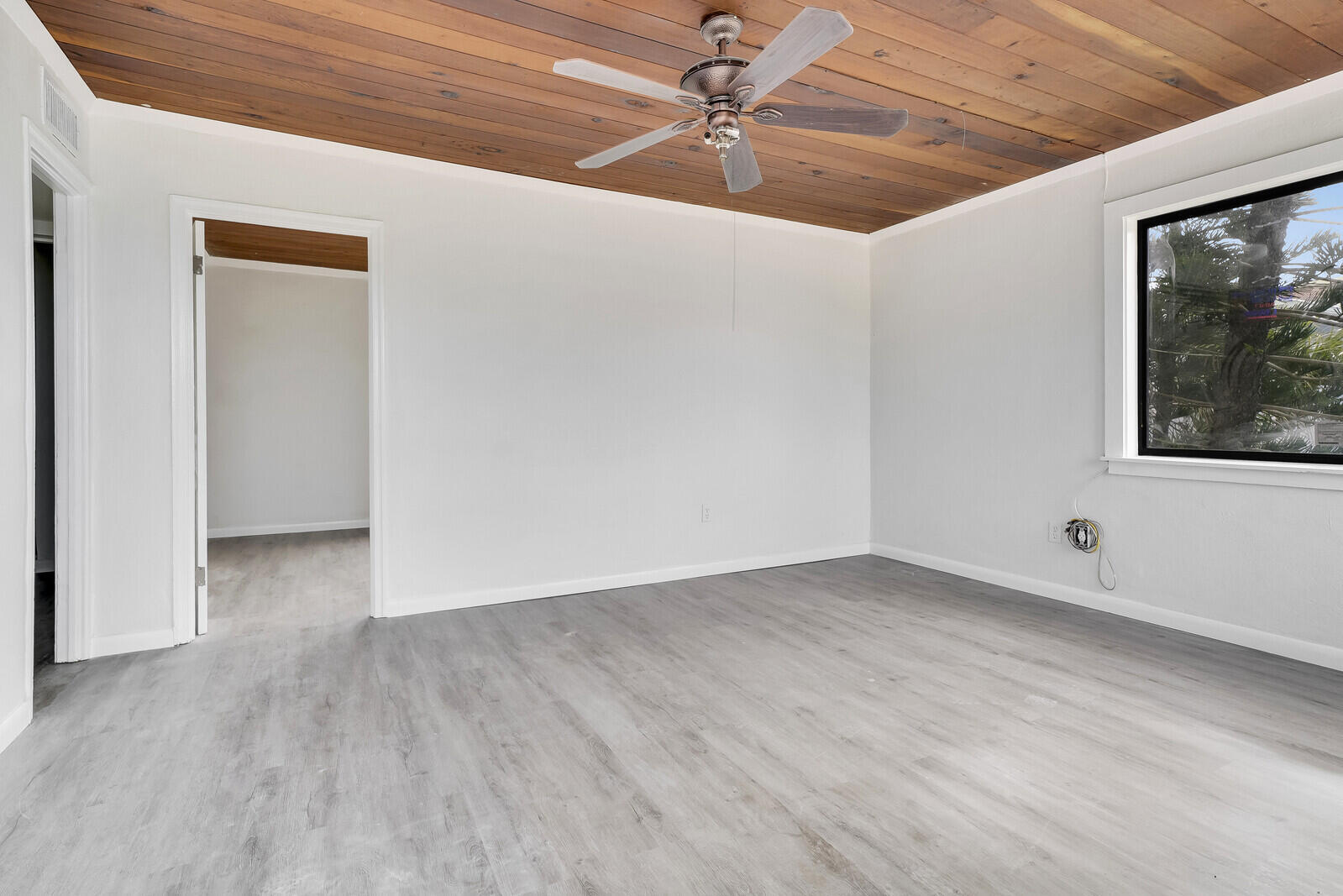 652 Hernando Street, Unit E Fort Pierce, FL 34949 - Photo 11 of 21 a view of an empty room with wooden floor