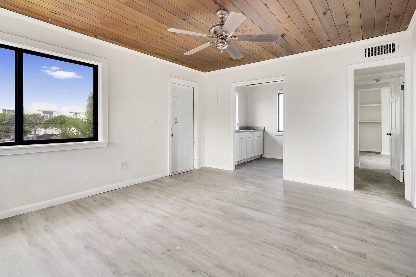 652 Hernando Street, Unit E Fort Pierce, FL 34949 - Photo 12 of 21 a view of a livingroom with a chandelier fan and windows
