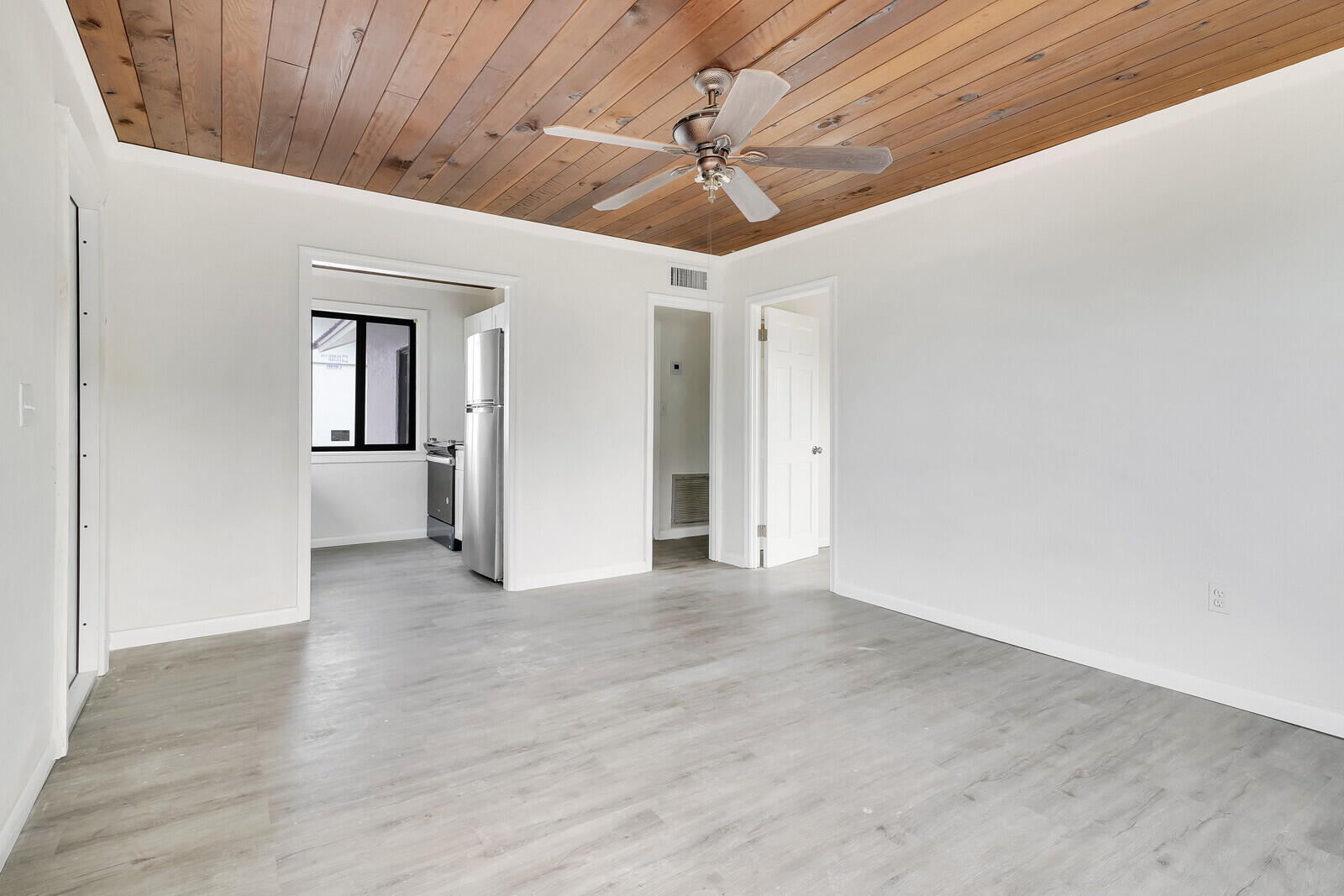 652 Hernando Street, Unit E Fort Pierce, FL 34949 - Photo 13 of 21 a view of a livingroom with wooden floor and a ceiling fan
