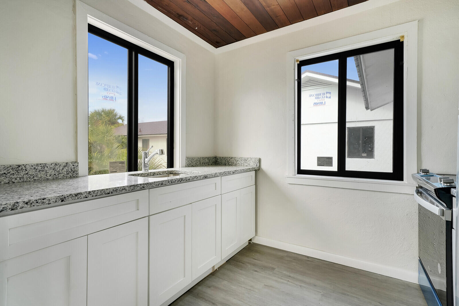 652 Hernando Street, Unit E Fort Pierce, FL 34949 - Photo 15 of 21 a bathroom with a granite countertop sink and a large mirror next to a window