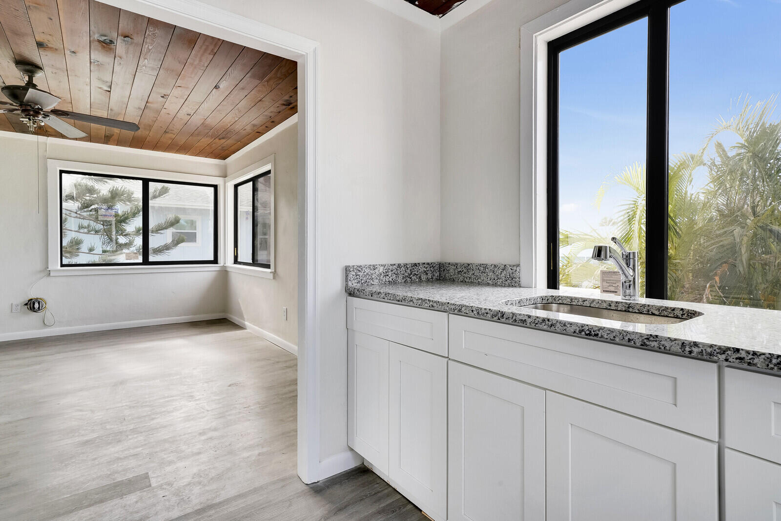 652 Hernando Street, Unit E Fort Pierce, FL 34949 - Photo 16 of 21 a bathroom with a granite countertop sink and a window