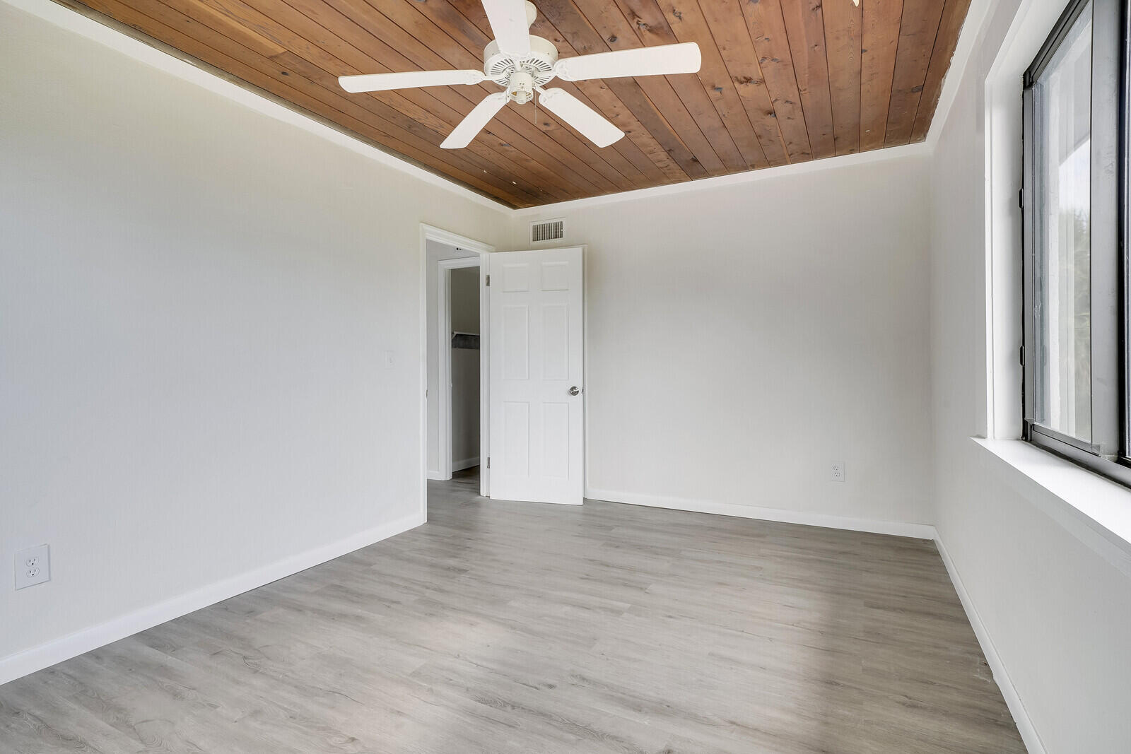 652 Hernando Street, Unit E Fort Pierce, FL 34949 - Photo 18 of 21 a view of an empty room with wooden floor
