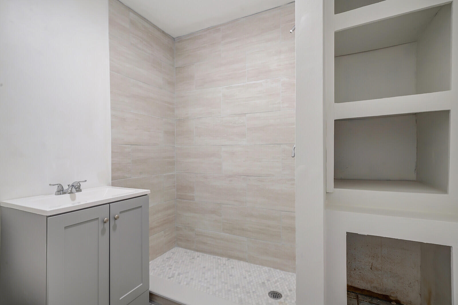 652 Hernando Street, Unit E Fort Pierce, FL 34949 - Photo 19 of 21 a bathroom with a sink and a mirror