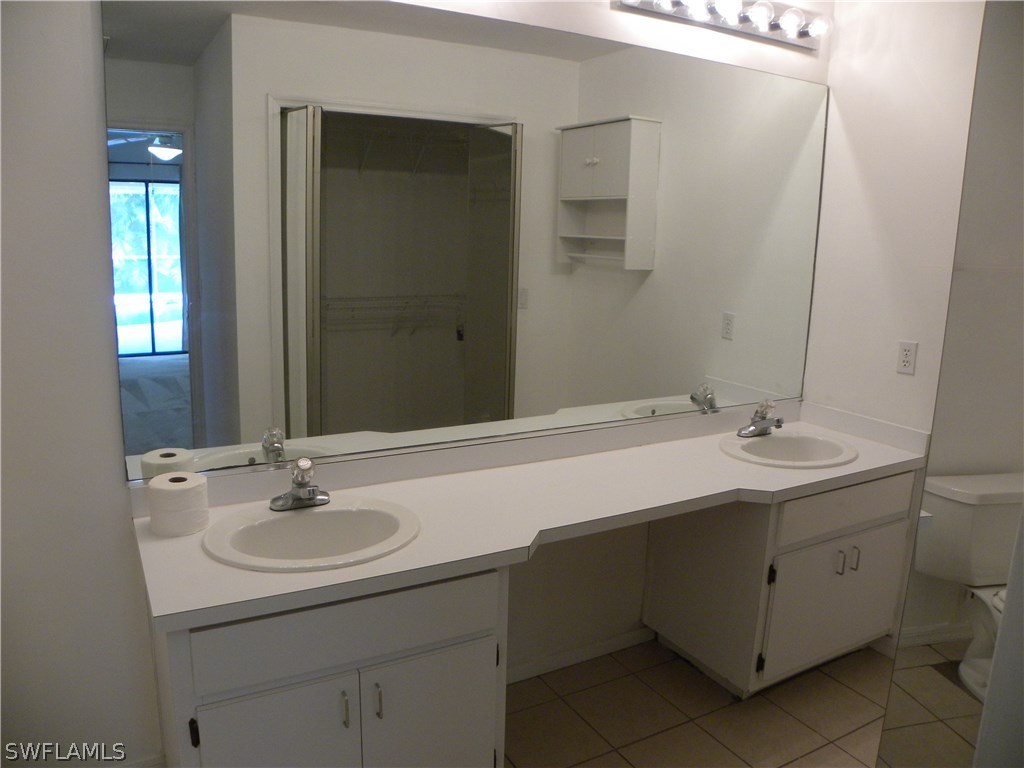 8381 Grove Road Fort Myers, FL 33967 - Photo 15 of 22 a bathroom with a sink and a mirror
