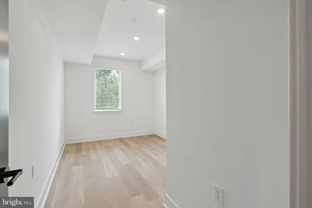 an empty room with windows and closet