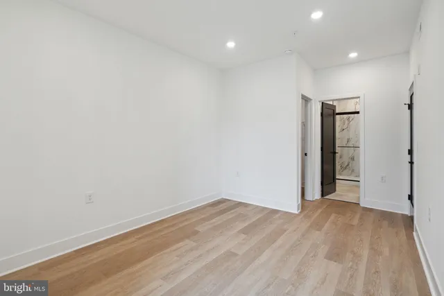 a view of hallway with wooden floor