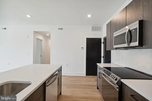 a kitchen that has a sink and a stove in it