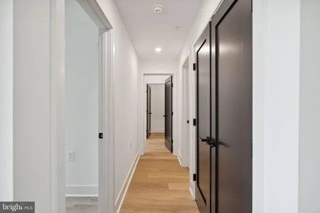 a view of a hallway with wooden floor
