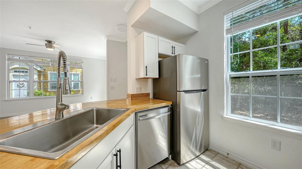 5561 Rosehill Road, Unit 104 Sarasota, FL 34233 - Photo 16 of 53 a kitchen with stainless steel appliances granite countertop a refrigerator and a sink