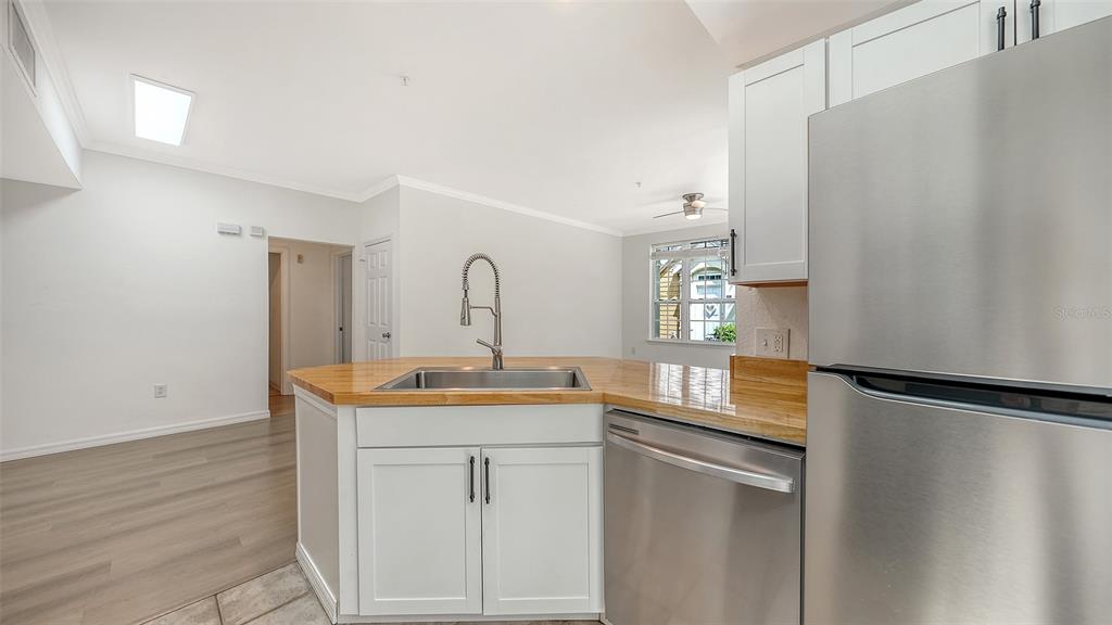 5561 Rosehill Road, Unit 104 Sarasota, FL 34233 - Photo 18 of 53 a kitchen with stainless steel appliances granite countertop a sink and a refrigerator