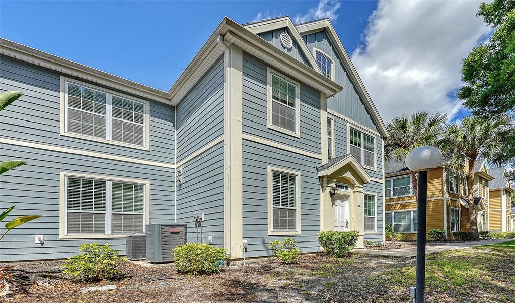 5561 Rosehill Road, Unit 104 Sarasota, FL 34233 - Photo 2 of 53 a front view of a house with garden
