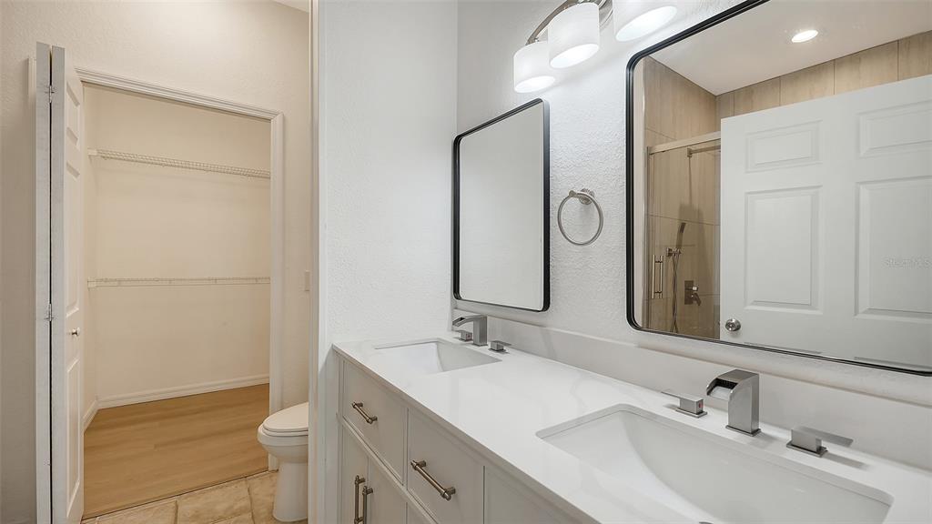 5561 Rosehill Road, Unit 104 Sarasota, FL 34233 - Photo 23 of 53 a bathroom with a granite countertop sink toilet and shower