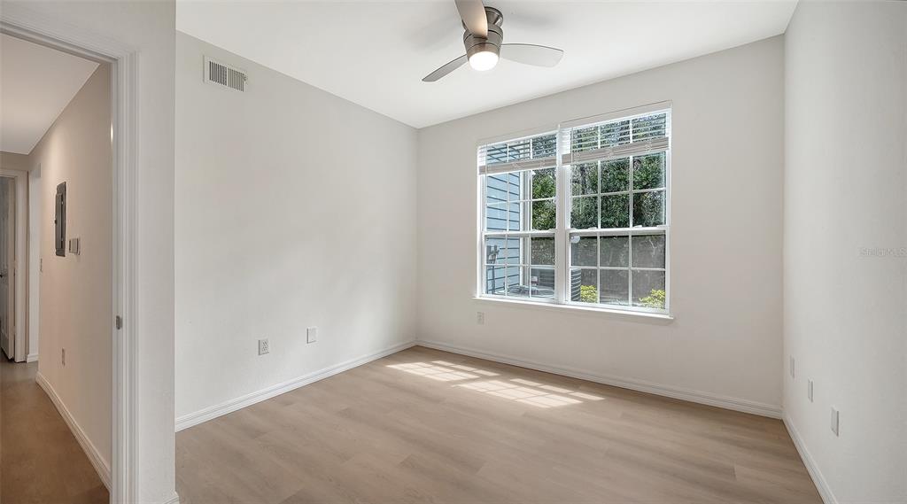 5561 Rosehill Road, Unit 104 Sarasota, FL 34233 - Photo 29 of 53 an empty room with a window and a ceiling fan