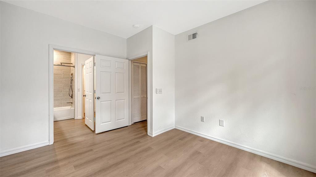 5561 Rosehill Road, Unit 104 Sarasota, FL 34233 - Photo 30 of 53 wooden floor in an empty room