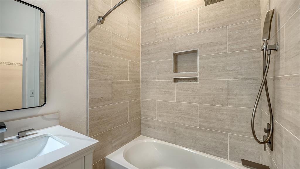 5561 Rosehill Road, Unit 104 Sarasota, FL 34233 - Photo 34 of 53 a bathroom with a sink a toilet and shower