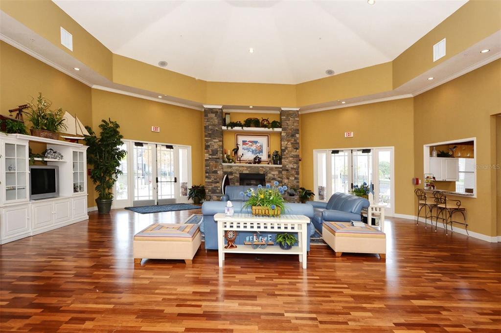 5561 Rosehill Road, Unit 104 Sarasota, FL 34233 - Photo 45 of 53 a living room with fireplace furniture and a floor to ceiling window