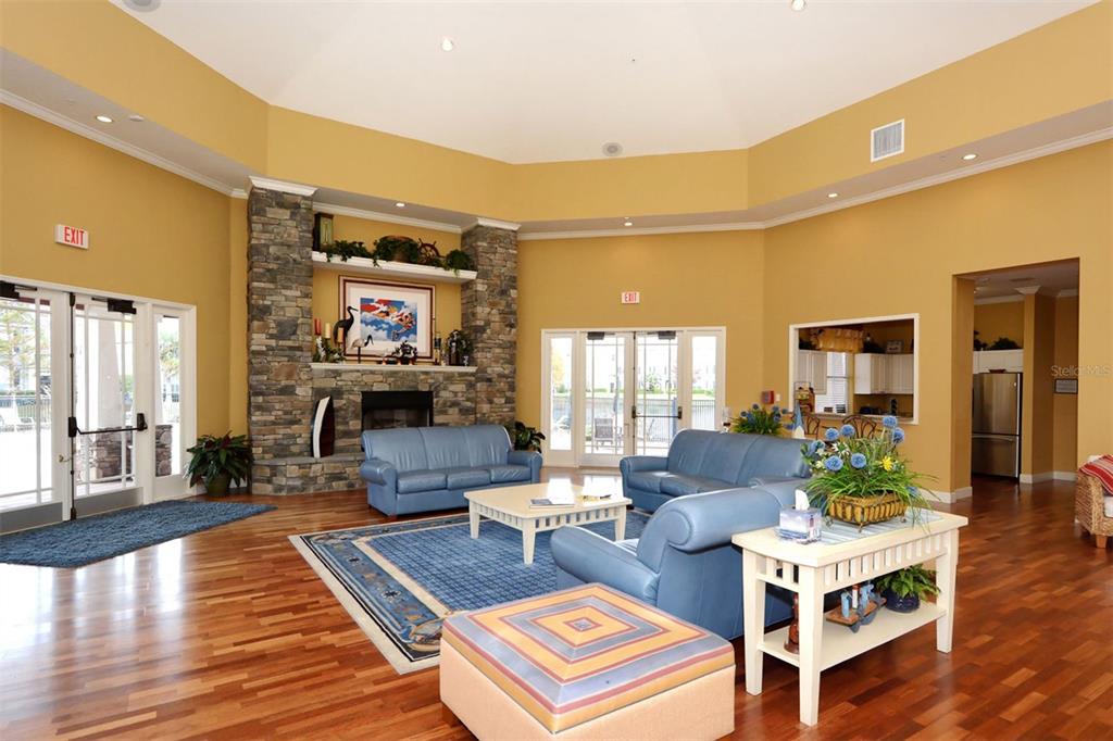 5561 Rosehill Road, Unit 104 Sarasota, FL 34233 - Photo 47 of 53 a living room with fireplace furniture and a wooden floor